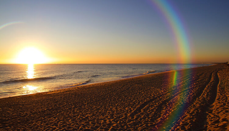 algarve bach with sunset across the sea