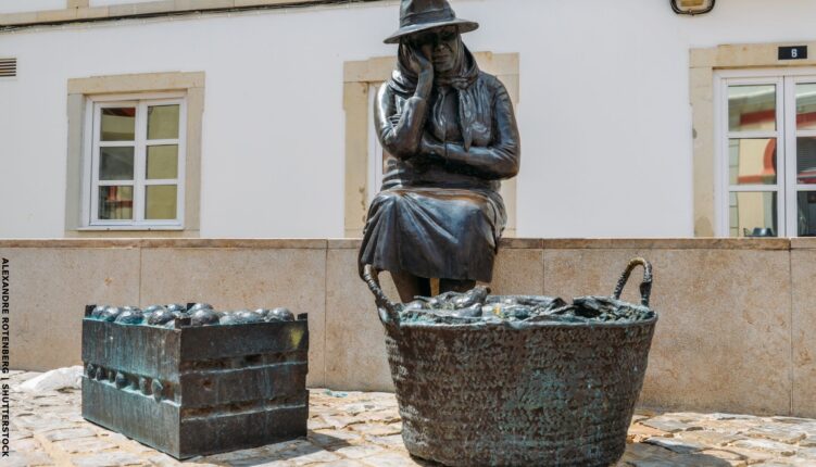 sculpture in loule of market lady with oranges and fish