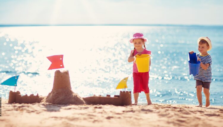 Children building a sand castle on Algarve beach, best-value destination