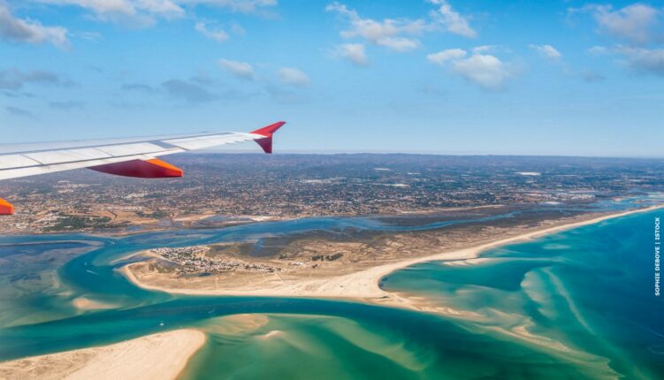 Wing of a plane above RIa Formosa, Algarve