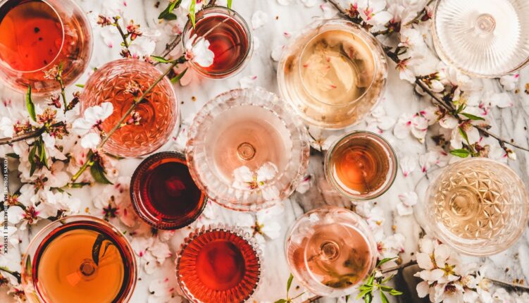 different glasses of wine amongst almond blossom