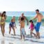 etended family playing in sea