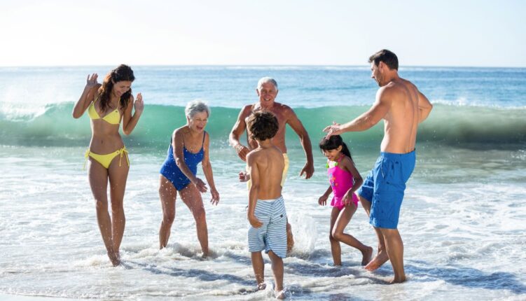 etended family playing in sea